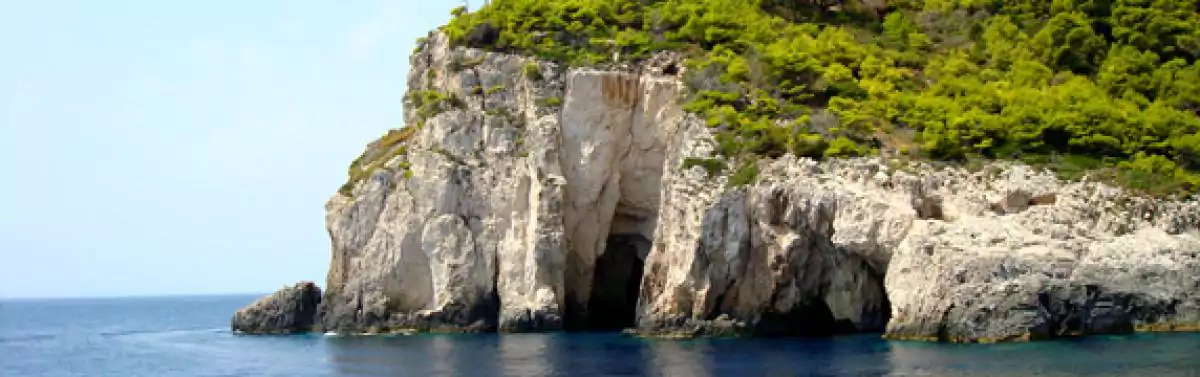 caves litter the white limestone at sea level
